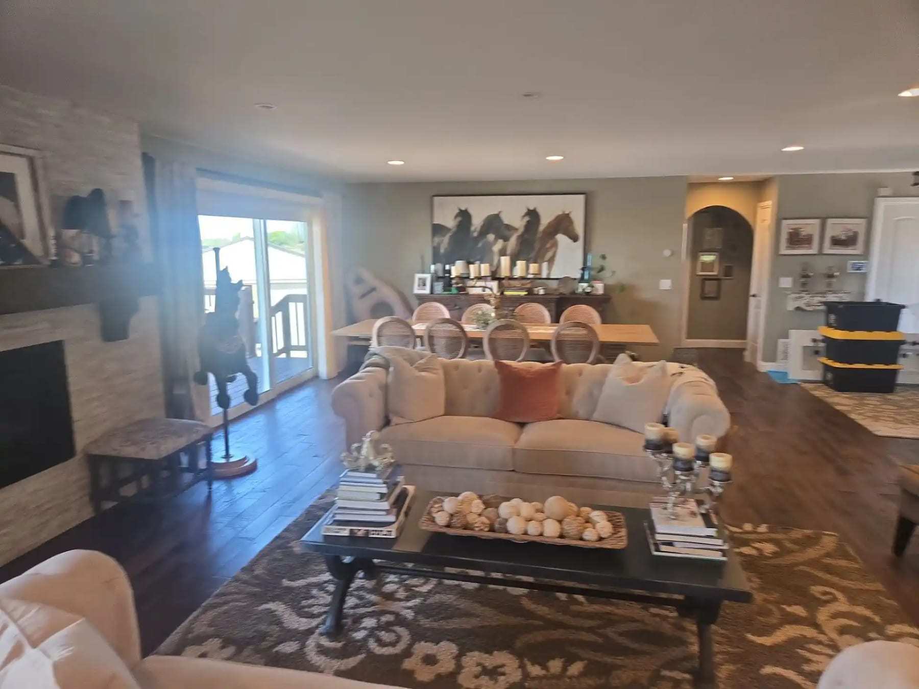 Furnished living room with a sofa, rug and dining area