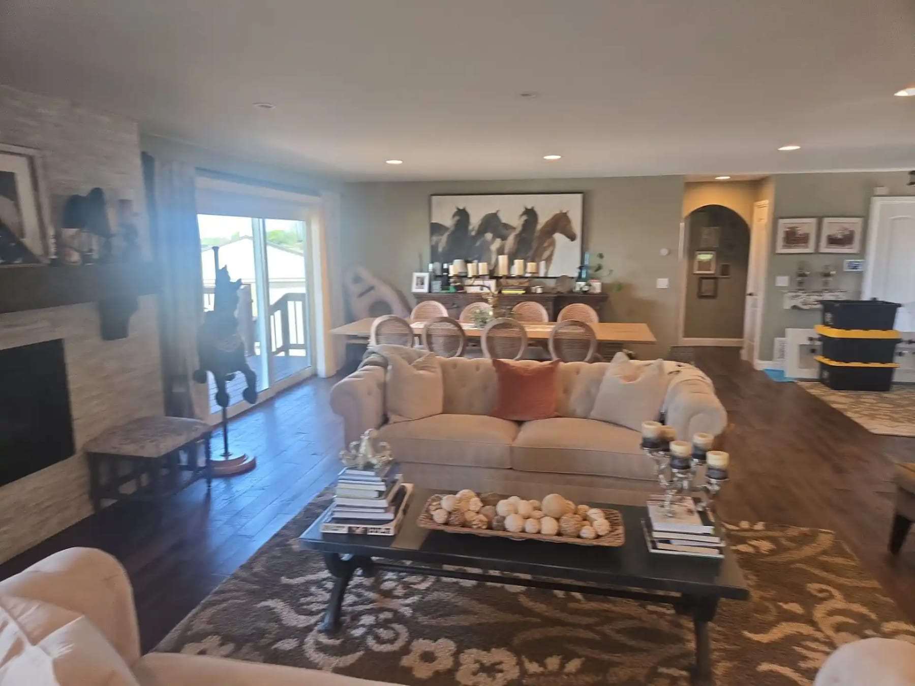 Furnished living room with a sofa, rug and dining area